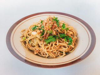 Mie Goreng Jawa or bakmi jawa or java noodle. Indonesian traditional street food noodles from central java or Yogyakarta, indonesia on white background.