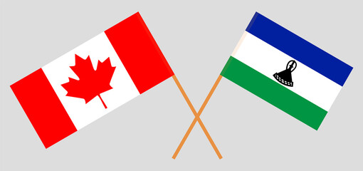 Crossed flags of the Kingdom of Lesotho and Canada. Official colors. Correct proportion