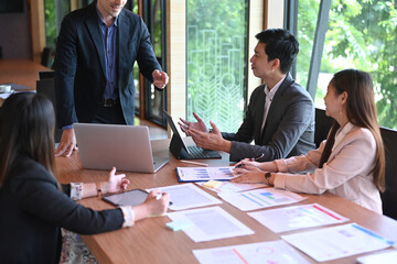 Successful businesspeople brainstorming and working on new project together in conference room.