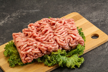 Raw pork minced meat over board