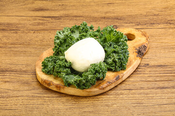 Soft mozzarella cheese over board