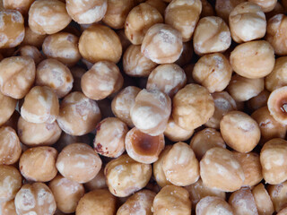 pile of peeled roasted hazelnut background. Detail