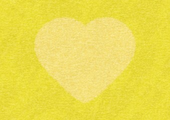 大きなハートマークのある黄色のフェルト生地の背景