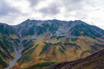 富山県立山町の立山の秋の紅葉の季節に登山している風景 Scenery of climbing Tateyama Mountain in Tateyama Town, Toyama Prefecture, Japan during the season of autumn leaves. 