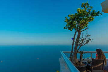 Fototapeta na wymiar ANTALYA, TURKEY: A tree with decorations at the top of the cable car station and a view of the Mediterranean Sea.