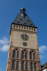 Fototapeta na wymiar Close, upward view of Old Gate (Alpoertel), a medieval clock tower gate, in Speyer, Germany, with blue sky background.