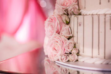 Beautiful wedding cake decorated with pink roses