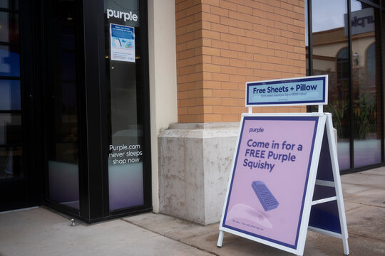 Tigard, OR, USA - Sep 30, 2021: Sidewalk promotional sign outside a Purple store in Tigard. Purple is an American comfort technology company specializing in the direct-to-consumer sale of mattresses.