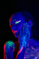 trendy neon makeup on the model. Woman with ultraviolet make-up. Disco night club chameleon. UV colors. Fashion of the future bright appearance. face Art. Copy space for text background