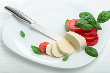 Mozzarella with tomatoes and basil.