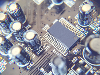 Selective focus. Close up photo of black printed circuit board with dip components. LED diods, resistors, capasitors and processor