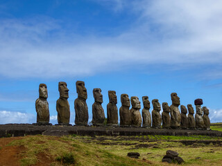 Moai statues with colorful clouds on Easter Island. Ahu Tongariki against Blue Sky, Chile, South...