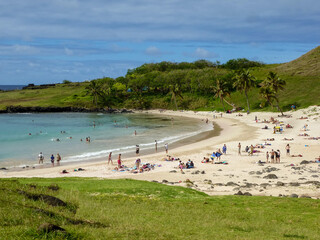 Fototapeta na wymiar Anakena beach on Easter Island. Sandy beach strip with coconut trees, moai statues and views of the Pacific Ocean, Chile, South America