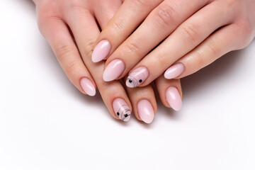 Ombre nail design with black spider web and stones on short sharp, oval nails close-up on a white background