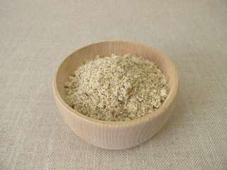 Gluten-free beechnut flour, ground beechnuts in a wooden bowl