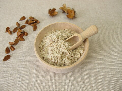 Gluten-free beechnut flour, ground beechnuts in a wooden bowl