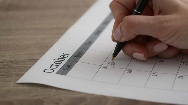 Planning Concept. Female Hand Taking Notes To Organizer Planner For October Month