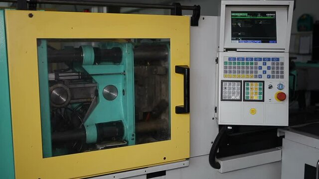  Injection molding machine during operation.Technological process of melting plastic at the enterprise.