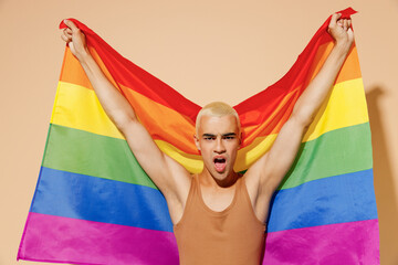 Young activist transsexual bisexual happy fun cool blond latin gay man with make up in beige tank...