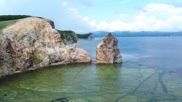 Flying through rocky cliffs just above the water