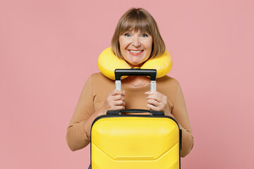 Traveler tourist happy smiling joyful fun mature elderly senior lady woman 55 years old wears brown...