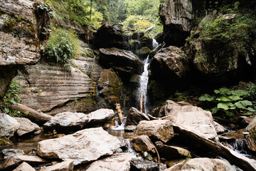 Mountain creek stream flowing through the autumn forest