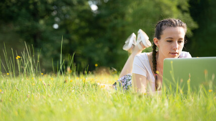 Woman online work outside. Laptop, computer business technology. Student girl working on tablet in summer nature park. People person outdoor. Escaped of office distance education concept.