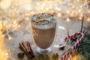 Christmas whipped cream hot cocoa with spices, candy canes and thuja branches