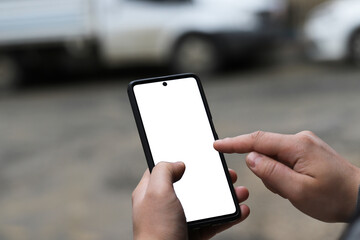 young hipster man using smartphone on the street