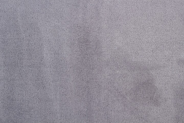 Fototapeta na wymiar Dark gray matte background of suede fabric, closeup