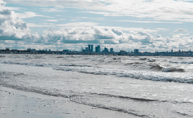 View of Tallinn from Pirita across the sea. Cold north sea, waves, city in the distance. cold shade.