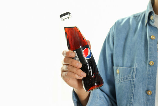 Odessa, Ukraine - September 23, 2021: Woman holds Pepsi bottle on white background