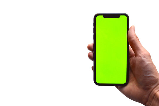 Photo of a hand holding a mobile device - iPhone template with green screen to add a customized image or text with chroma key - Smartphone blank screen to show an app, game or website on display