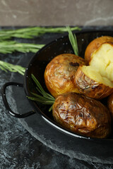Concept of tasty food with baked potato on black smokey table