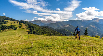 Fototapeta na wymiar Biker on MTB bike at mountains trail in Low Tatras mountains, Slovakia