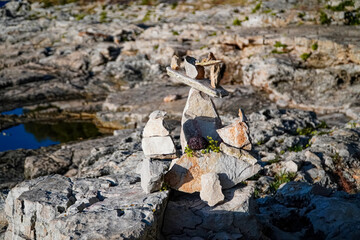 balancing stones , composition of stones on the background of rocks, rocky shore 