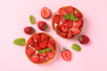 Strawberry tarts on pink background, top view