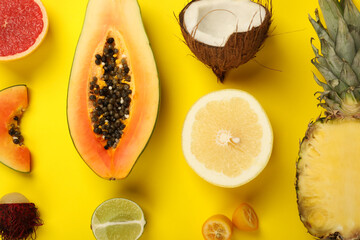 Exotic fruits set on yellow background, top view