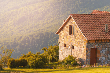 A stone house in the mountains is a refuge for tourists and hikers. The concept of travel and real estate