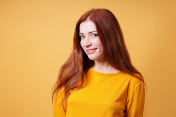 happy young woman with long red hair smiling