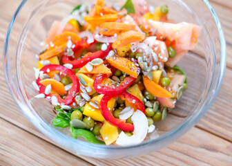 Vegetable salad in a transparent bowl with pumpkin and pepper