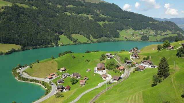 A breathtaking aerial view of rural landscapes on the shore of Lungern lake, Switzerland