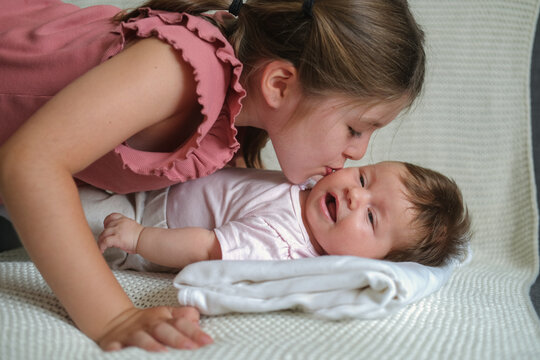 Big Sister Kiss Little Happy Baby Girl. Happy Family