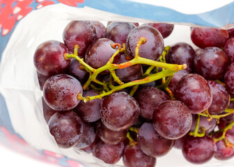 A bunch of large grapes in a package
