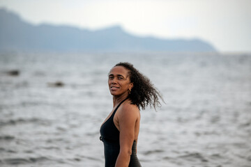 Fototapeta na wymiar Woman in bikini in a volcanic beach