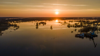 Aerial atmospheric view on big river. Aerial drone view of river landscape in sunny sunset. Nature concept.