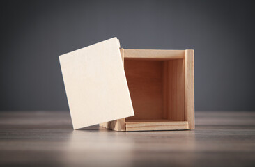 Small wooden box on the wooden table.