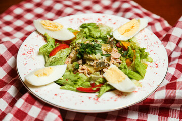 Salad with canned tuna, avocado, tomato, boiled egg, lettuce, parsley with olive oil dressing, lemon juice and grain mustard.
