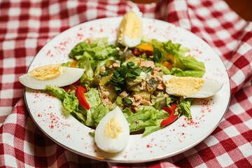 Salad with canned tuna, avocado, tomato, boiled egg, lettuce, parsley with olive oil dressing, lemon juice and grain mustard.