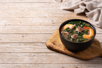 Beef, okra stew and spinach soup in bowl on wooden table. Copy space